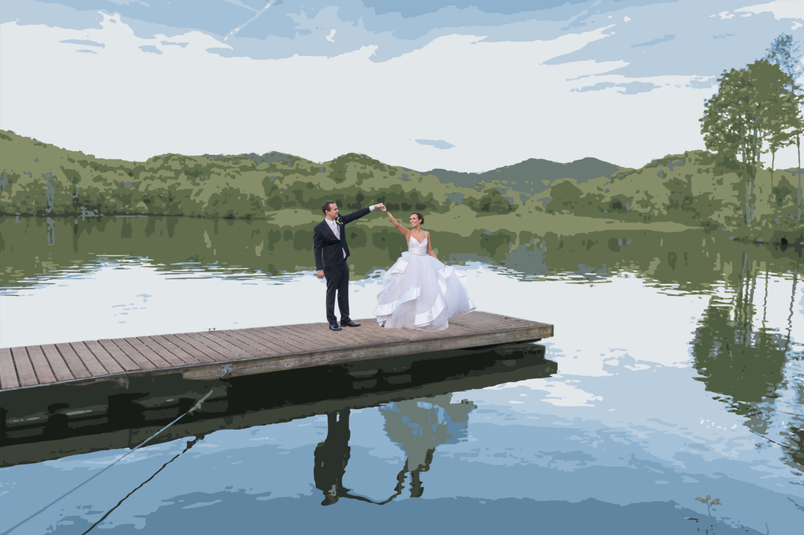 A newly married couple twirls on a wooden dock over a calm lake, with mountains and trees reflected in the water.