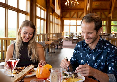 Man and women eating dinner at a rustic, charming restaurant