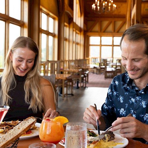 Man and women eating dinner at a rustic, charming restaurant