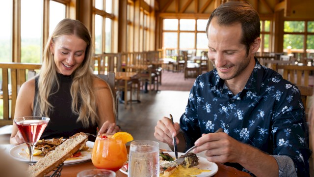 Man and women eating dinner at a rustic, charming restaurant
