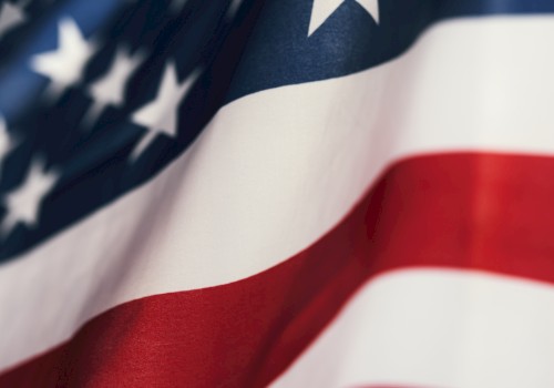 The image shows a close-up of the American flag, featuring stars and stripes in red, white, and blue.