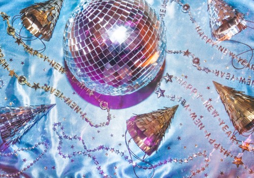 The image shows a disco ball, party hats, and 